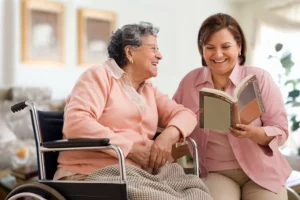 Woman reading book to an elderly